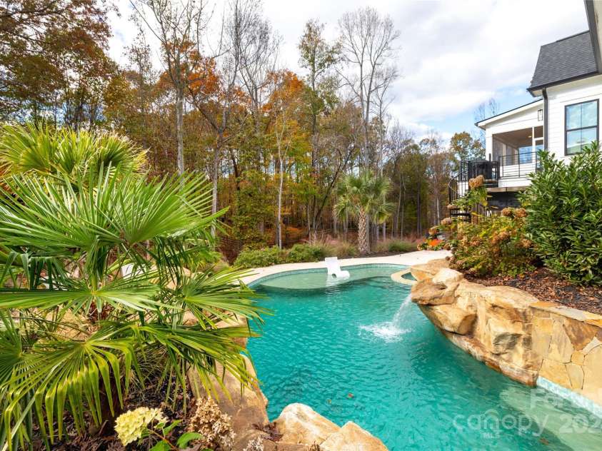 124 Direct Drive, Mooresville, NC 28117.  MLS# CAR4202552, YatesRealty ID 625. Saltwater pool with tanning ledge and seating bench.