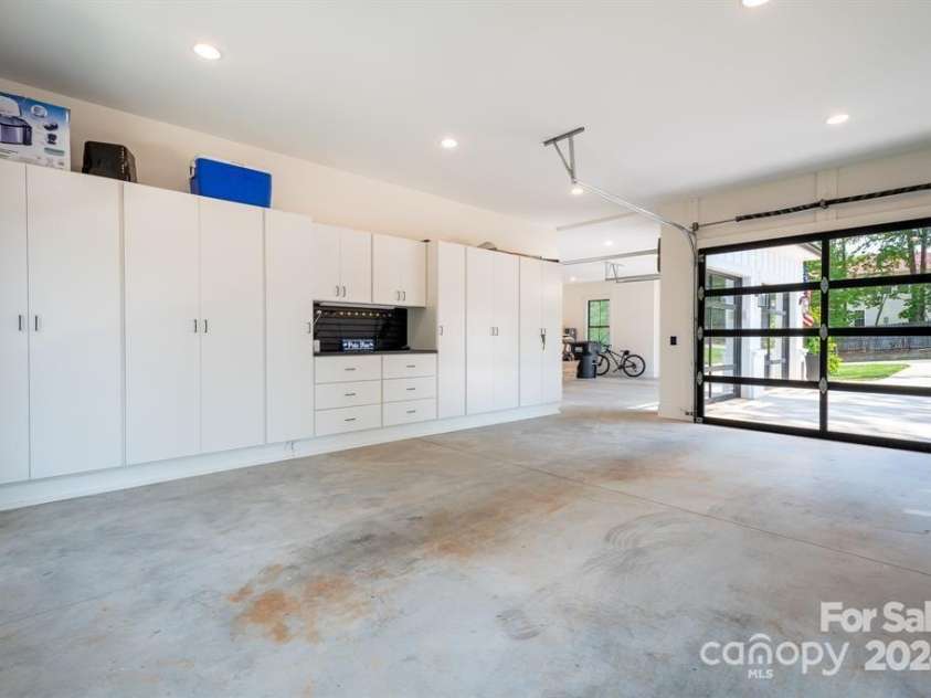 124 Direct Drive, Mooresville, NC 28117.  MLS# CAR4202552, YatesRealty ID 625. Storage galore and workshop in the 3rd garage bay with plenty of room to park as well.