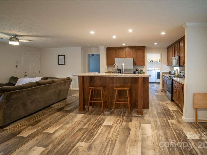 2257 Messer Road, Valdese, NC 28690.  MLS# CAR4209555, YatesRealty ID 6252. Kitchen, living room and laundry in background