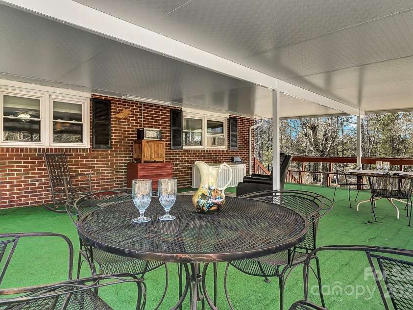 44 Tuttle Road, Hendersonville, NC 28792.  MLS# CAR4318659, YatesRealty ID 6261. Host a dinner party rain or shine on this covered deck!