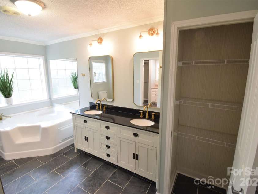 121 Silver Fox Court, Mount Holly, NC 28120.  MLS# CAR4241766, YatesRealty ID 6269. Garden Tub, Dual Sink Vanity and Linen Closet