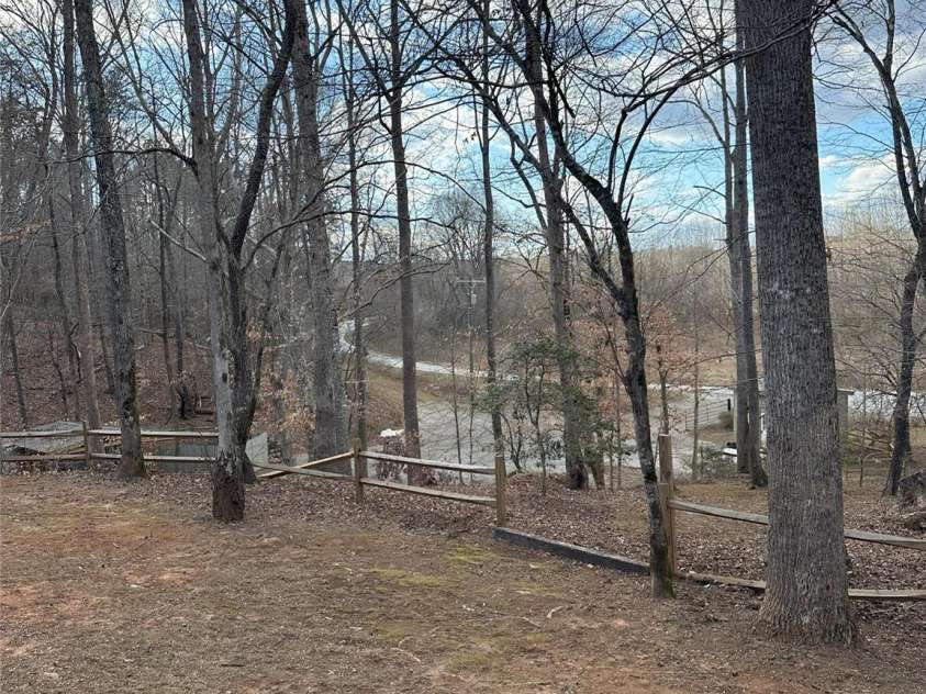 1597 Cleghorn Mill Road, Rutherfordton, NC 28139.  MLS# CAR4213254, YatesRealty ID 627. This property is two parcels combined for ~6 acres. Lower area offers a large area for RV/Horse Trailer parking and electric hookup.  Tiny home with full bath is also available. (Tiny Home is under construction a