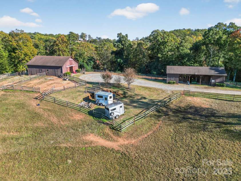 777 River Road, Tryon, NC 28782.  MLS# CAR4316725, YatesRealty ID 6286. Aerial - Equine Buildings