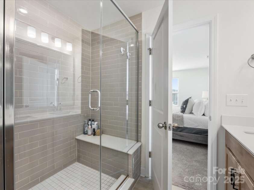1542 Cedar Tree Drive, Belmont, NC 28012.  MLS# CAR4238594, YatesRealty ID 6288. Tiled shower with bench in primary ensuite