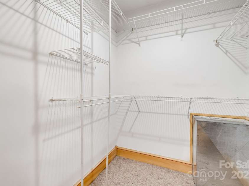 57 Stillwater Springs Road, Burnsville, NC 28714.  MLS# CAR4295423, YatesRealty ID 629. One of THREE Primary Bedroom Closet 57 Stillwater Springs Road Burnsville, NC