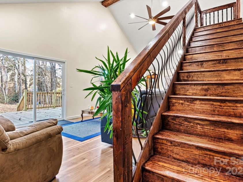 6051 Pointe West Lane, Vale, NC 28168.  MLS# CAR4092329, YatesRealty ID 63. Stairway up to loft bedroom from living room