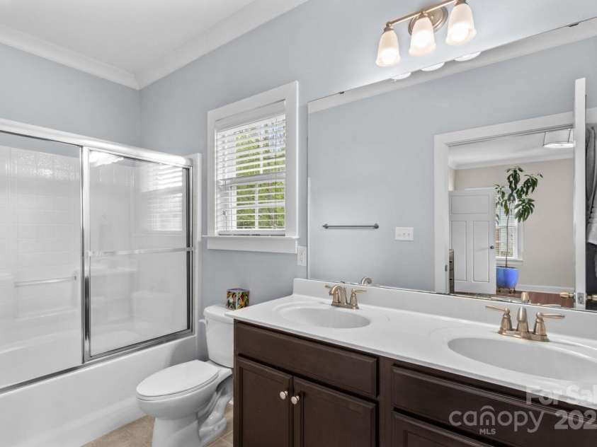 12746 Bravington Road, Huntersville, NC 28078.  MLS# CAR4245023, YatesRealty ID 6302. Double vanity sink and shower and tub combo.