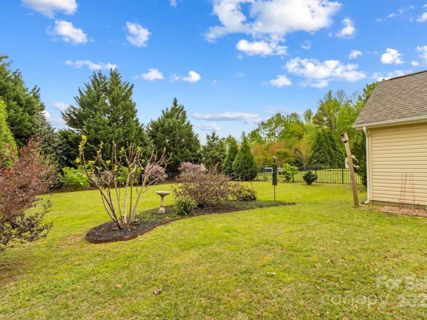 12746 Bravington Road, Huntersville, NC 28078.  MLS# CAR4245023, YatesRealty ID 6302. Mature green giants add privacy, and lilacs and hydrangeas add vibrant color.