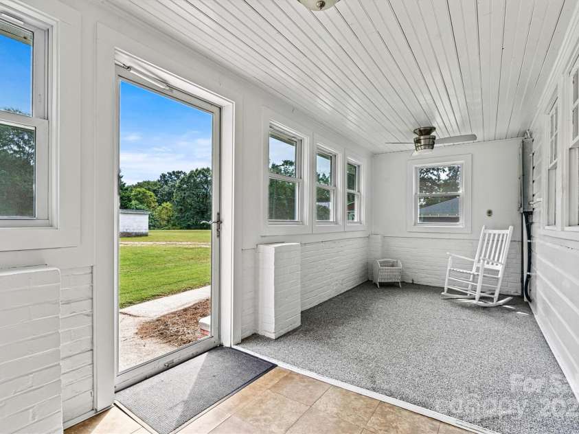 128 10th Street, Hildebran, NC 28637.  MLS# CAR4184496, YatesRealty ID 6303. Enclosed Back Porch/Sidewalk View