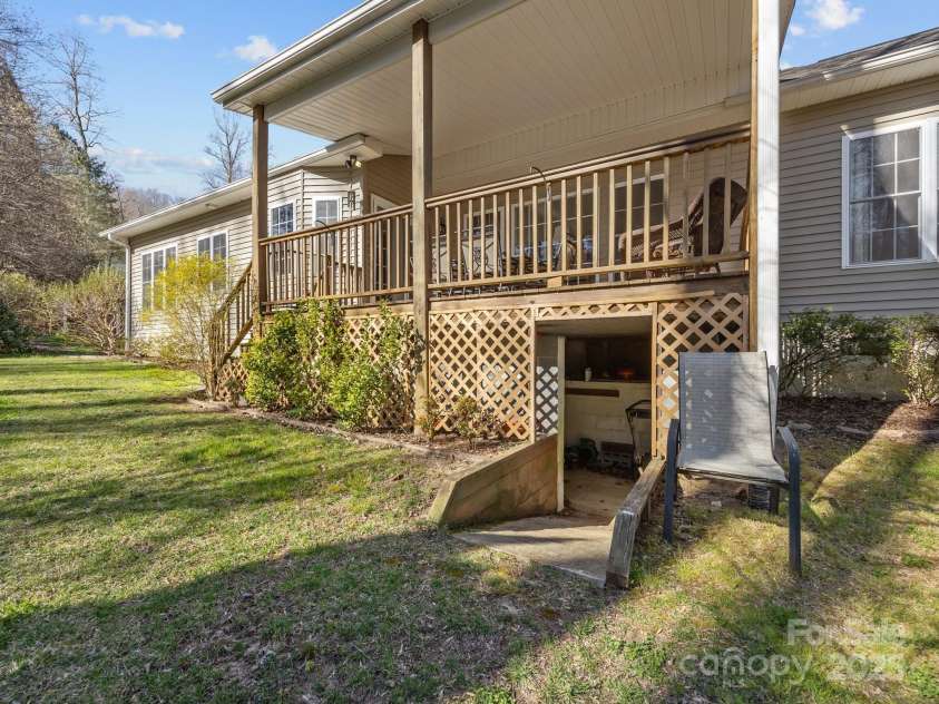 43 Golden Pond Way, Hendersonville, NC 28791.  MLS# CAR4234066, YatesRealty ID 6305. The opening leads to a semi-enclosed storage area for lawn equipment.