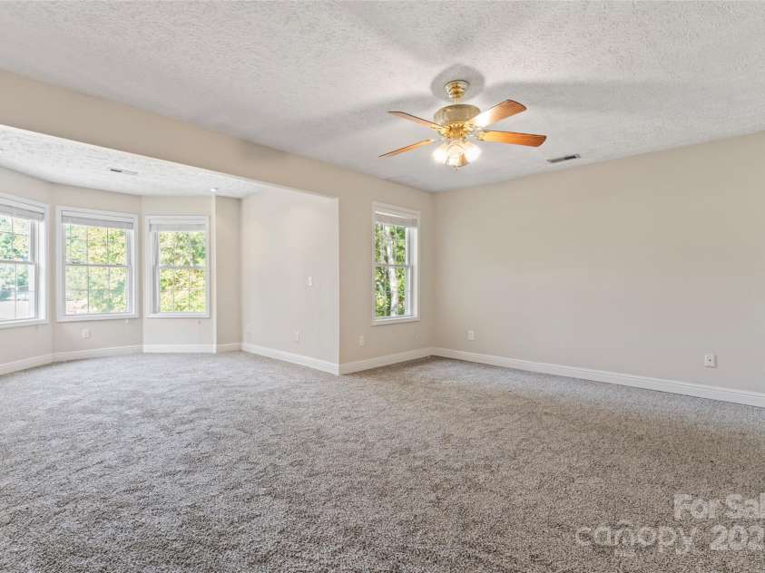 2720 Lentz Road, China Grove, NC 28023.  MLS# CAR4309058, YatesRealty ID 6325. 400 sq ft in the massive primary bedroom with two walk-in closets and a primary en-suite bathroom with a jetted tub. The beautiful bay window allows natural lighting, and the extra space allows for a reading area, desk, c