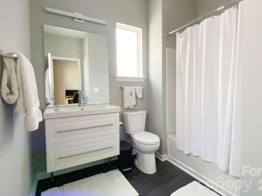 446 Worthington Avenue, Charlotte, NC 28203.  MLS# CAR4352271, YatesRealty ID 6327. Second full bath with floating vanity and same under cabinet lighting