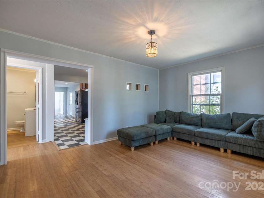 27 W Stewart Street, Asheville, NC 28806.  MLS# CAR4247708, YatesRealty ID 6351. Living Room Flows into Kitchen