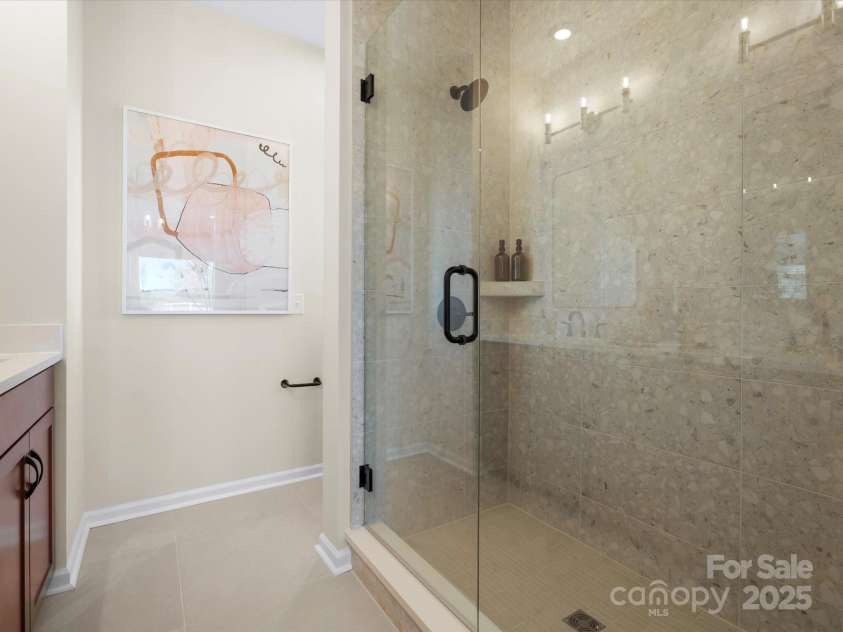 5040 Beirut Drive, Charlotte, NC 28217.  MLS# CAR4330479, YatesRealty ID 6361. Frameless Tiled Primary Shower.
