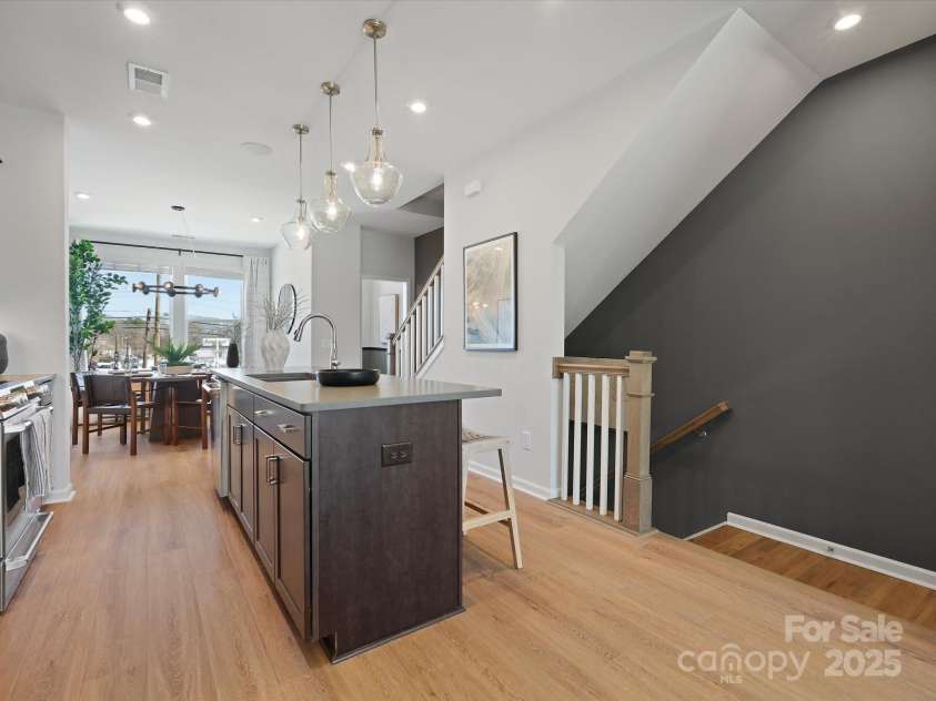 5032 Beirut Drive, Charlotte, NC 28217.  MLS# CAR4330424, YatesRealty ID 6362. Central Kitchen Anchoring the Home in Warmth.
