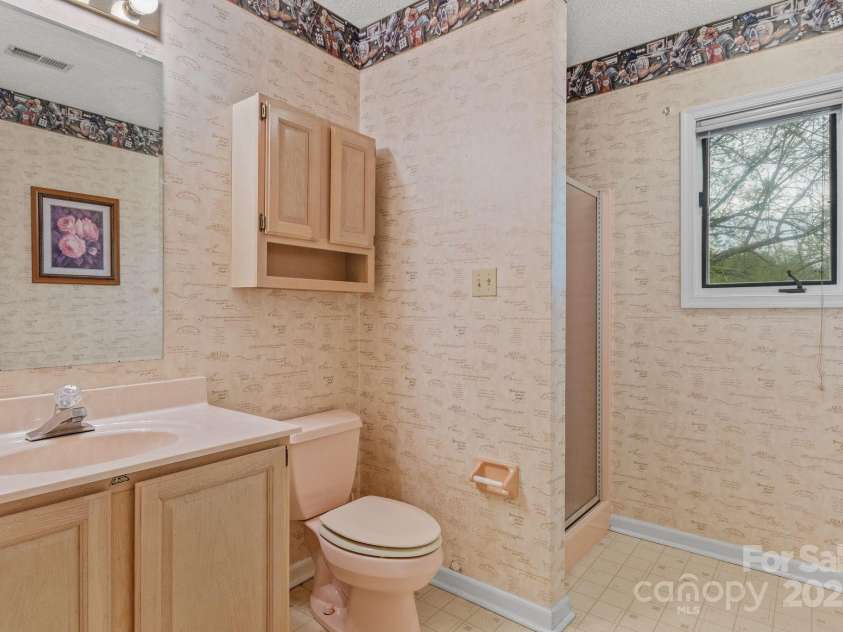 6 Valley Drive, Weaverville, NC 28787.  MLS# CAR4246234, YatesRealty ID 6369. Lowest level downstairs bathroom.