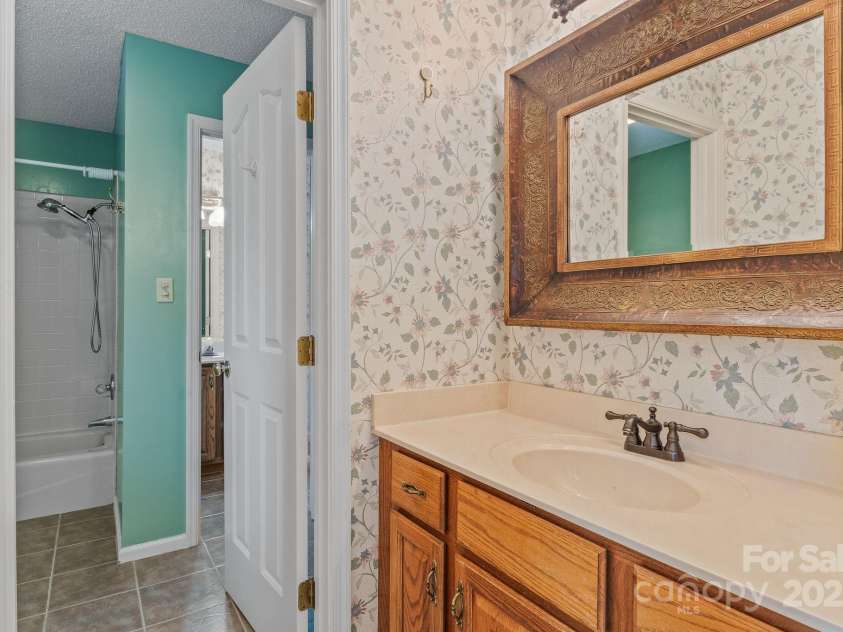 6 Valley Drive, Weaverville, NC 28787.  MLS# CAR4246234, YatesRealty ID 6369. Upstairs bathroom that connects across 2 rooms.