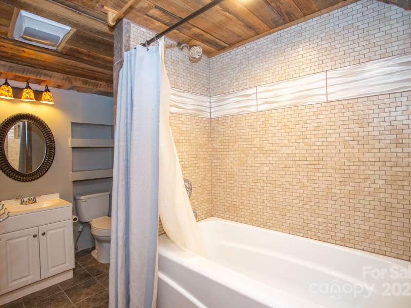 9 Eller Ford Road, Weaverville, NC 28787.  MLS# CAR4203004, YatesRealty ID 6373. Downstairs bathroom