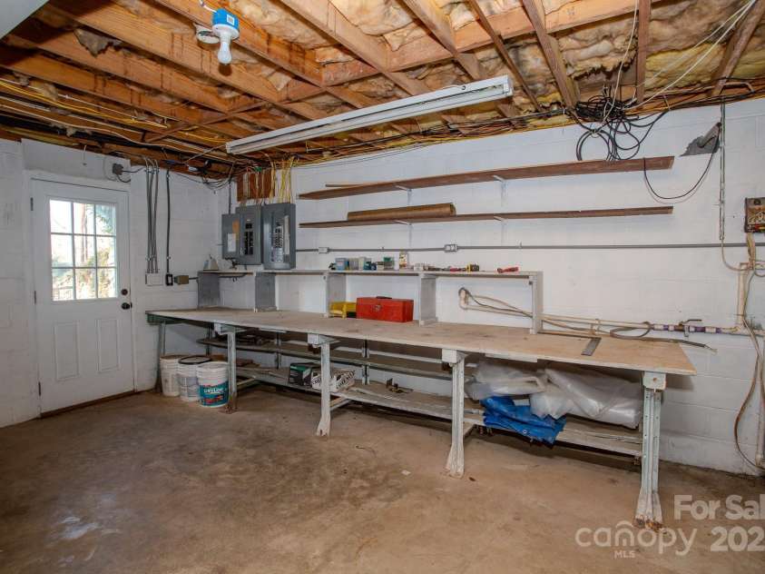9 Eller Ford Road, Weaverville, NC 28787.  MLS# CAR4203004, YatesRealty ID 6373. Downstairs workbench