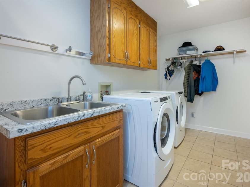 344 Hague Drive, Columbus, NC 28722.  MLS# CAR4350359, YatesRealty ID 6377. Laundry room with sink and additional storage
