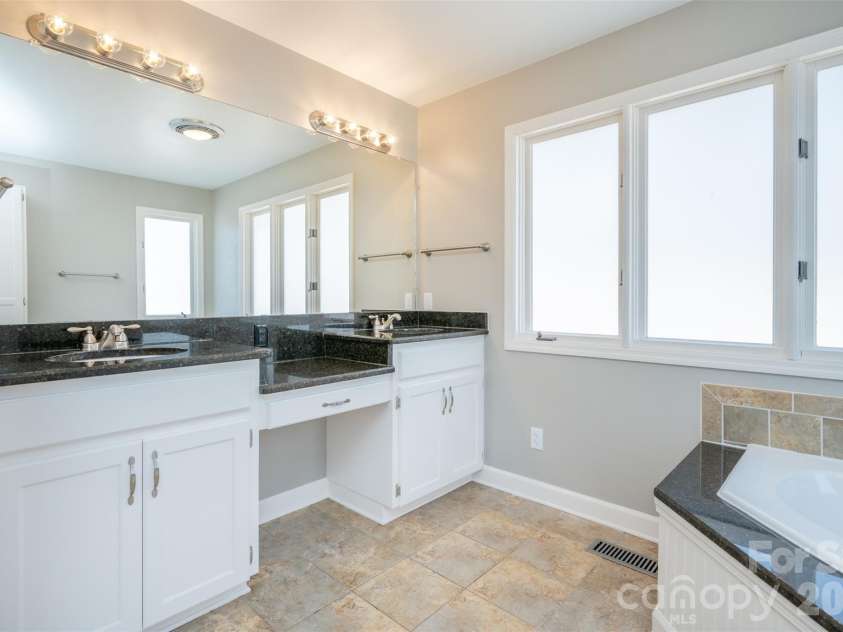 344 Hague Drive, Columbus, NC 28722.  MLS# CAR4350359, YatesRealty ID 6377. Primary bath featuring granite vanities