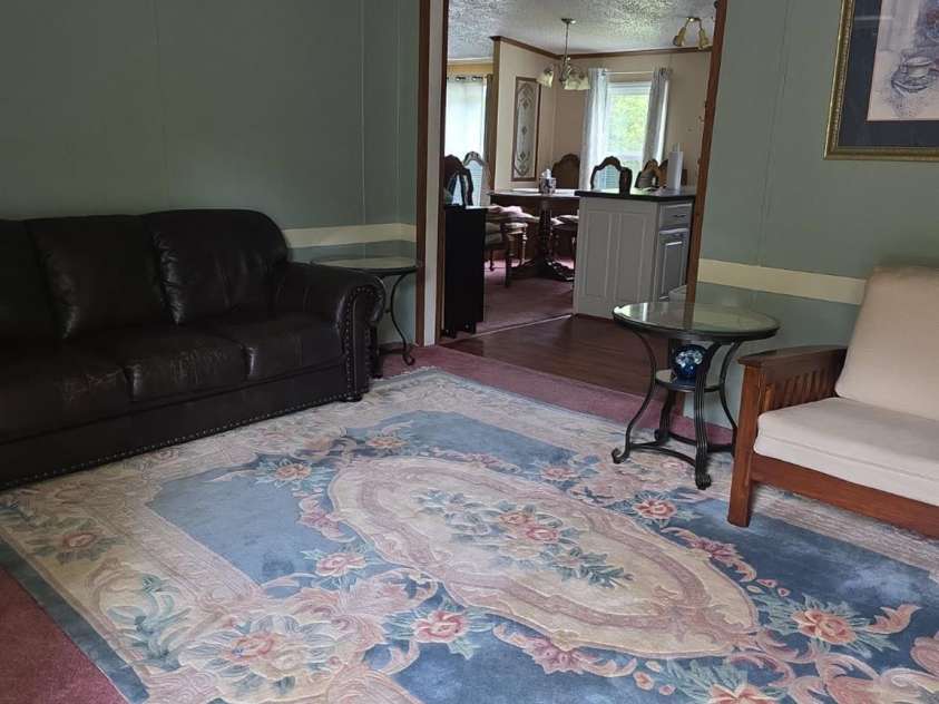 927 Miles Road, Jefferson, SC 29718.  MLS# CAR4247335, YatesRealty ID 6385. Living room looking towards dining area