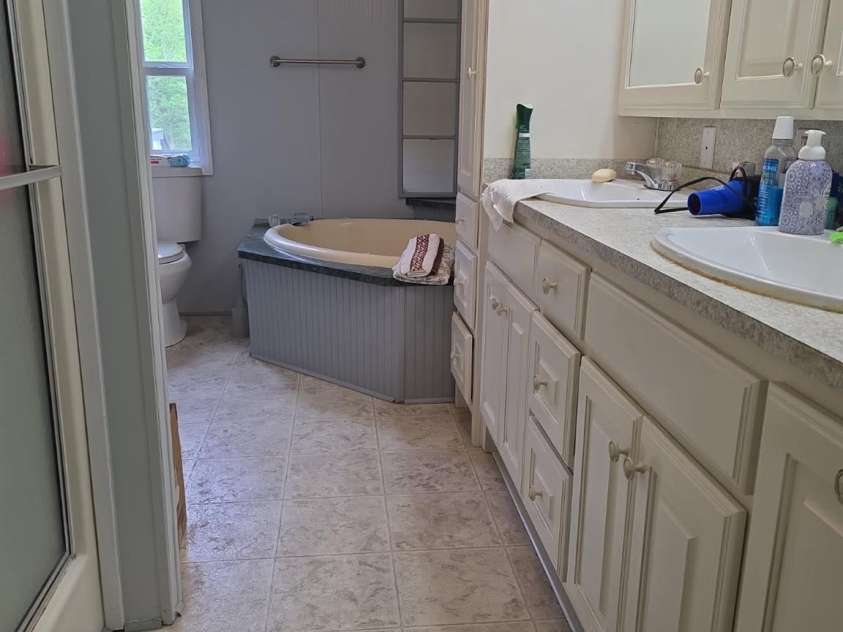 927 Miles Road, Jefferson, SC 29718.  MLS# CAR4247335, YatesRealty ID 6385. Primary Bathroom with soaking tub, separate shower, double vanity and extra cabinets