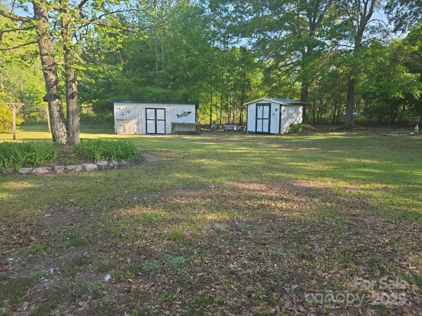 927 Miles Road, Jefferson, SC 29718.  MLS# CAR4247335, YatesRealty ID 6385. Two storage buildings in back yard