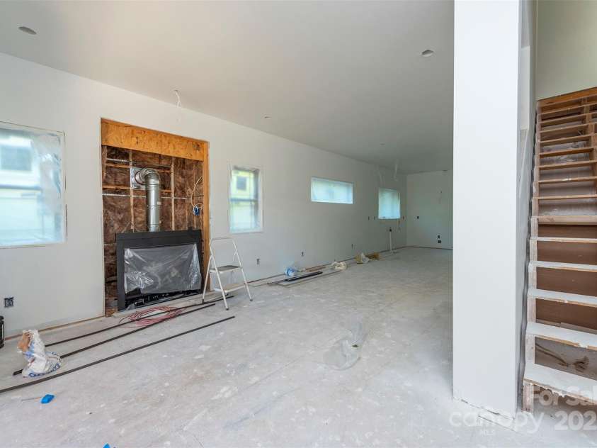 105 Bartram Way, Black Mountain, NC 28711.  MLS# CAR4330649, YatesRealty ID 6391. Living space looking towards kitchen with cozy fireplace.