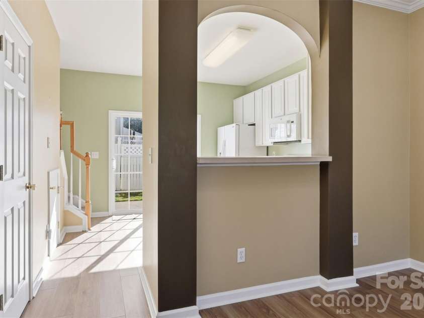 727 Shellstone Place, Fort Mill, SC 29708.  MLS# CAR4359626, YatesRealty ID 6396. From living room toward kitchen, half bath on left