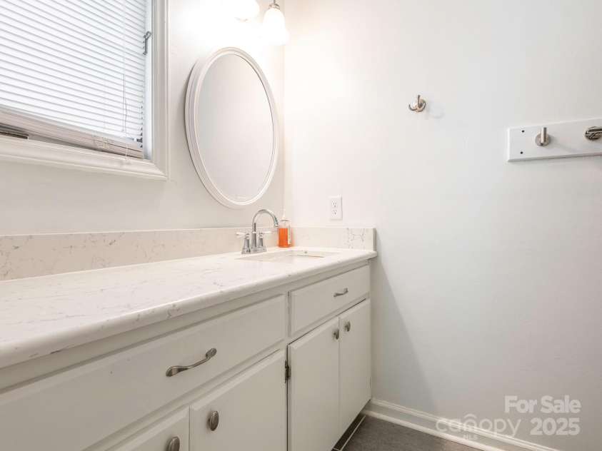 1022 Kenilworth Court, Concord, NC 28027.  MLS# CAR4243363, YatesRealty ID 6397. Primary bath with lovely quartz counters & white cabinets