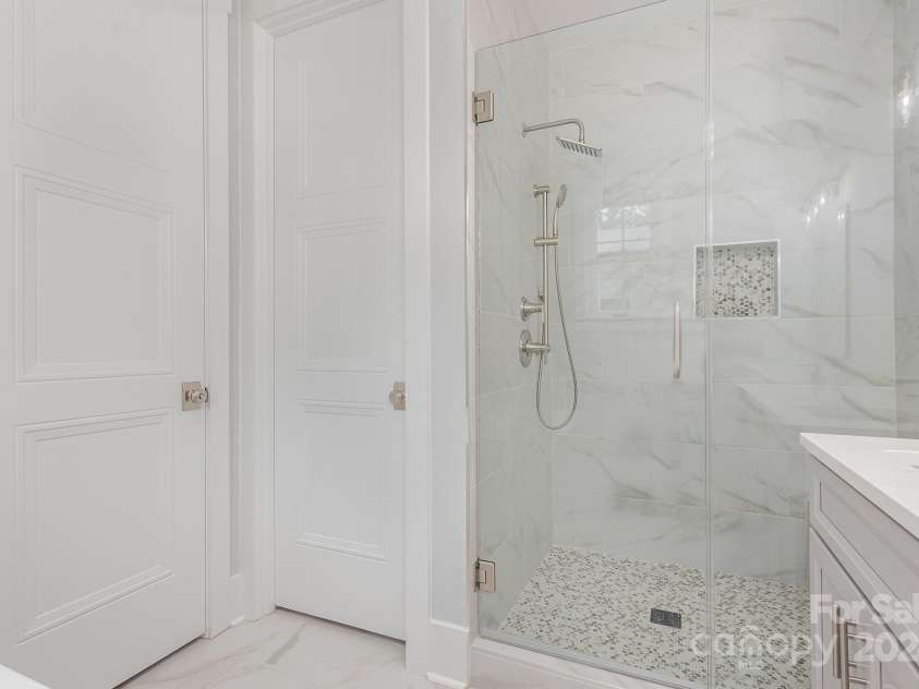 2305 Sanders Avenue, Charlotte, NC 28216.  MLS# CAR4187672, YatesRealty ID 6413. Primary bath shower