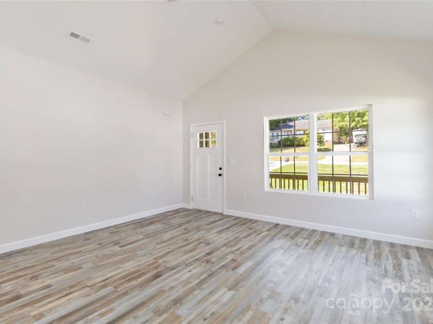 213 Sheffield Drive, York, SC 29745.  MLS# CAR4099016, YatesRealty ID 642. Living room vaulted ceiling with fan