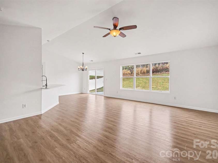 7941 Mossycup Drive, Charlotte, NC 28215.  MLS# CAR4292875, YatesRealty ID 6426. Living Room into Dining & kitchen