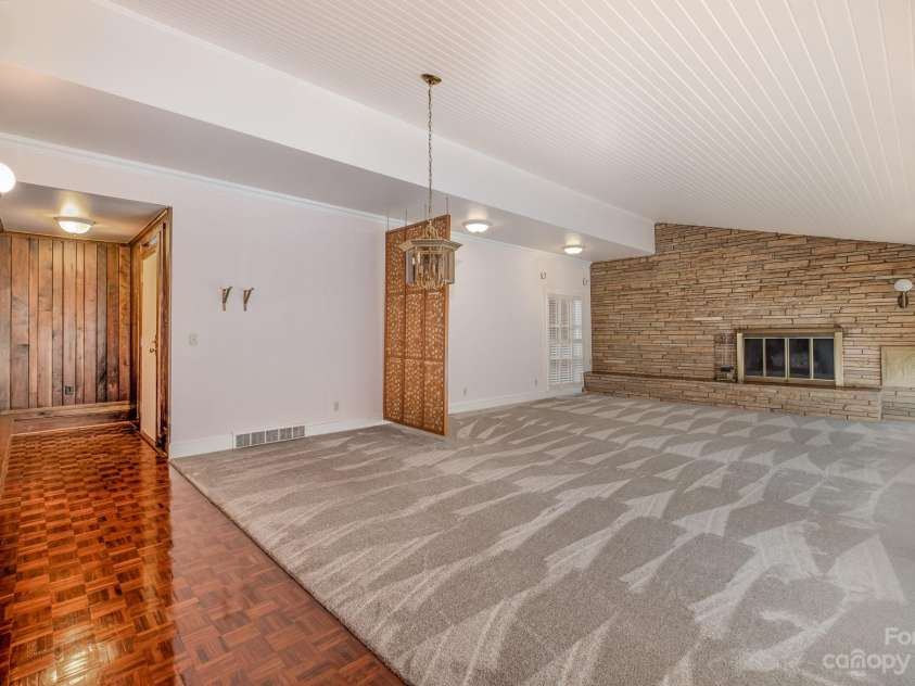 2756 Peachtree Road, Statesville, NC 28625.  MLS# CAR4072282, YatesRealty ID 644. Front door entrance to living room/dining room area separate by a work of art and grounded by a stone wall and fireplace.  