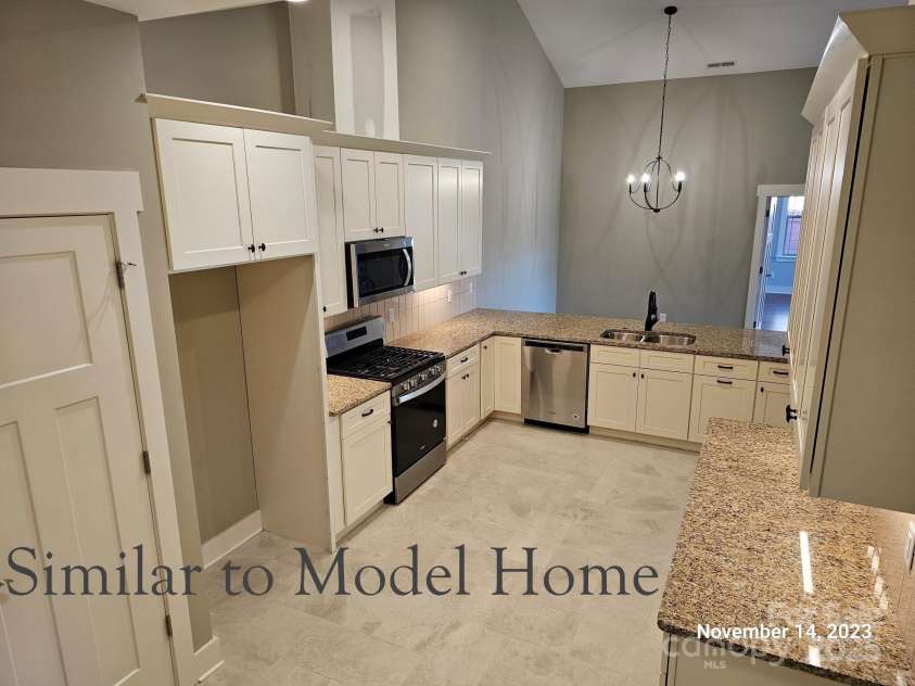 30-S-1 Brookstone Place, Candler, NC 28715.  MLS# CAR4290030, YatesRealty ID 6446. Kitchen Overlooking Dining Room