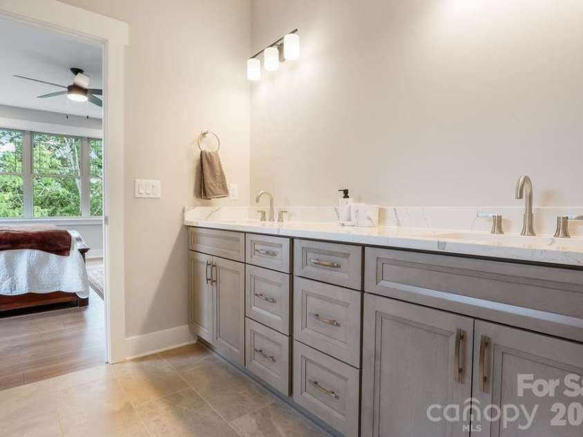 19 Craftsman Overlook Ridge, Arden, NC 28704.  MLS# CAR4342379, YatesRealty ID 6451. Primary bathroom with dual sinks and cabinetry. 