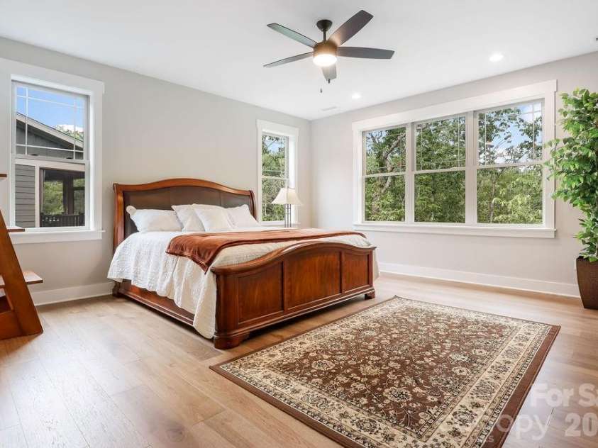 19 Craftsman Overlook Ridge, Arden, NC 28704.  MLS# CAR4342379, YatesRealty ID 6451. Primary suite features ceiling fans and lots of light and room for a king sized bed.