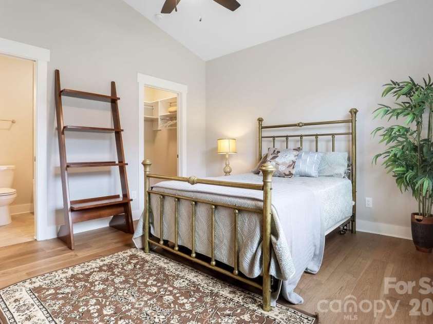 19 Craftsman Overlook Ridge, Arden, NC 28704.  MLS# CAR4342379, YatesRealty ID 6451. Secondary, main level bedroom has walk-in closet and ensuite bathroom, vaulted ceiling with ceiling fan.