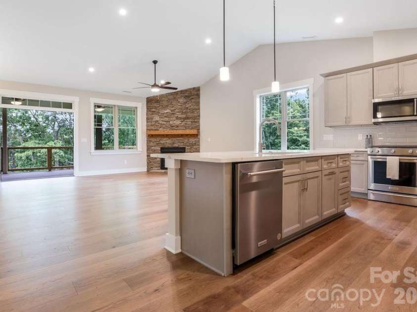 19 Craftsman Overlook Ridge, Arden, NC 28704.  MLS# CAR4342379, YatesRealty ID 6451. Spacious living area flows to covered Trex decking with peaceful wooded views