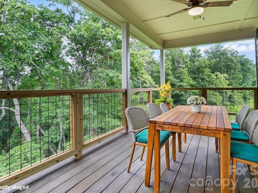 19 Craftsman Overlook Ridge, Arden, NC 28704.  MLS# CAR4342379, YatesRealty ID 6451. Virtually staged trex deck off main living area with dual ceiling fans.