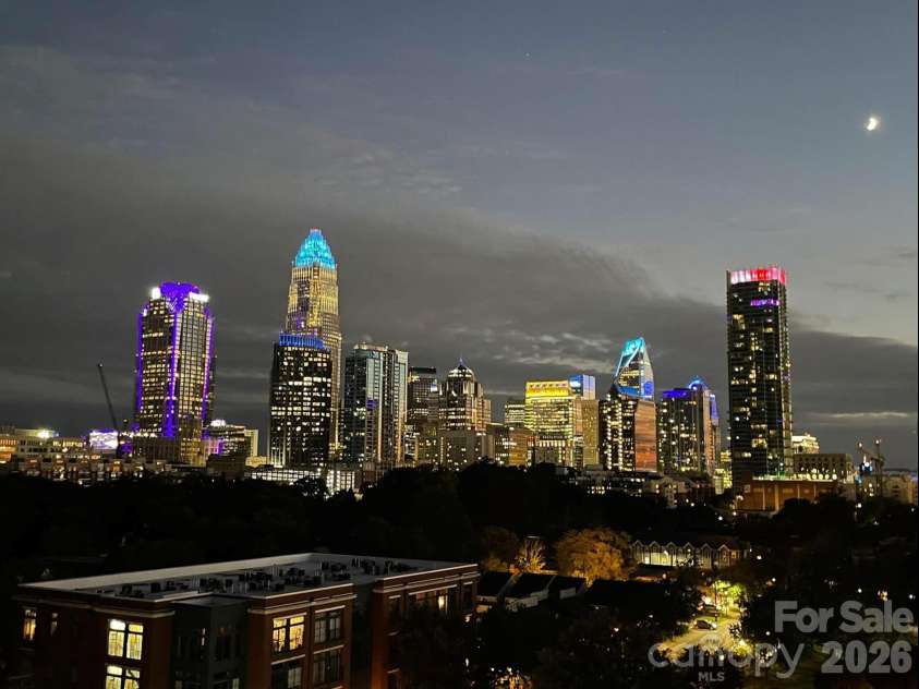 715 Graham Street, Charlotte, NC 28202.  MLS# CAR4383984, YatesRealty ID 6452. Nighttime skyline view from living room