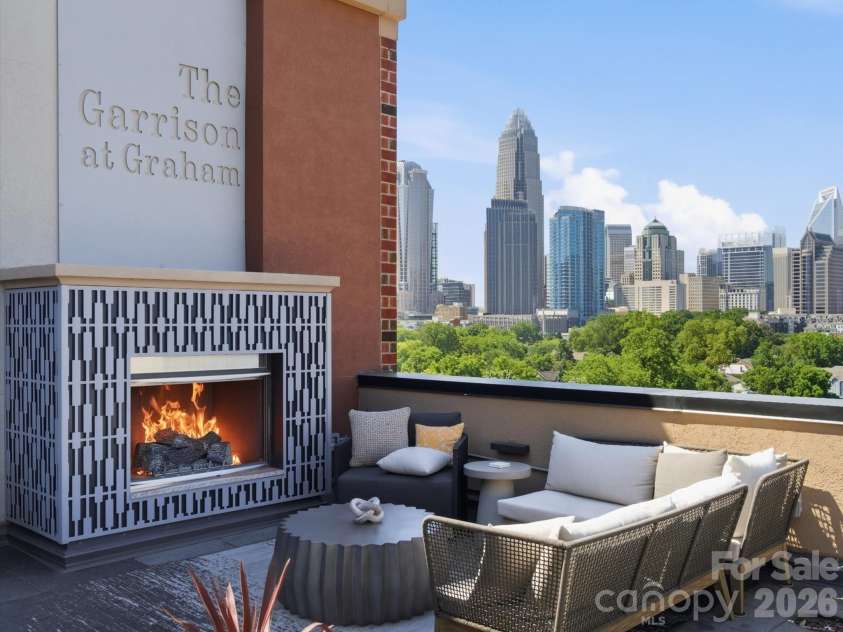 715 Graham Street, Charlotte, NC 28202.  MLS# CAR4383984, YatesRealty ID 6452. Shared rooftop terrace with skyline views, lounge areas, fireplaces, and outdoor kitchen 