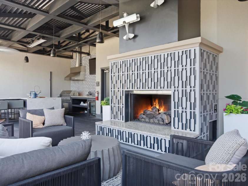 715 Graham Street, Charlotte, NC 28202.  MLS# CAR4383984, YatesRealty ID 6452. Shared rooftop terrace with skyline views, lounge areas, fireplaces, and outdoor kitchen 