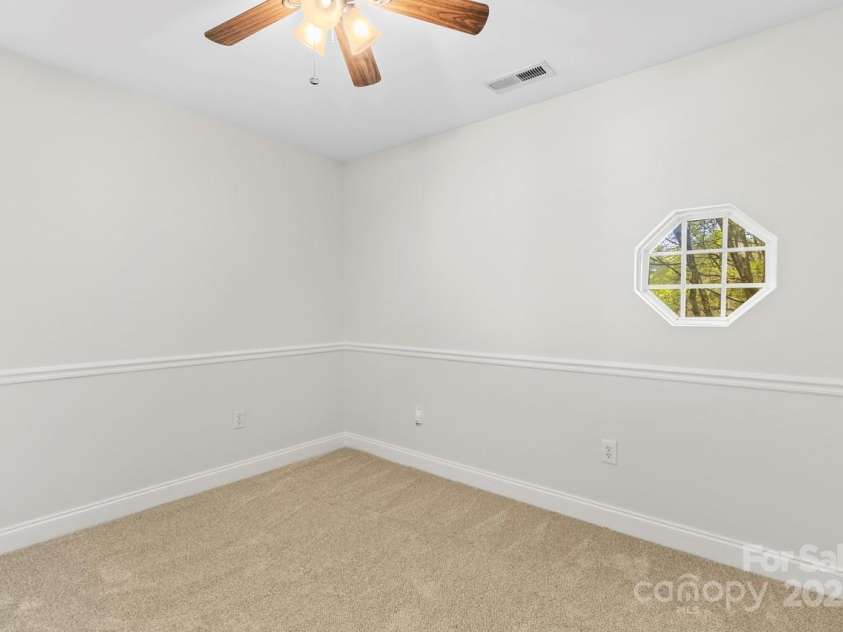 13206 Meadowmere Road, Huntersville, NC 28078.  MLS# CAR4245792, YatesRealty ID 6454. Bedroom 3 features a ceiling fan, portal window and chair rail molding