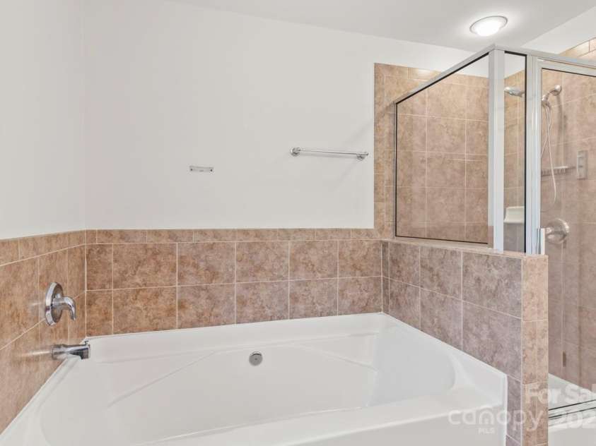13206 Meadowmere Road, Huntersville, NC 28078.  MLS# CAR4245792, YatesRealty ID 6454. Soaking tub and tile shower in Primary Bathroom