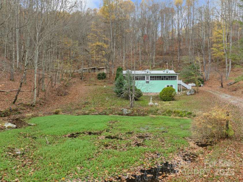 61 Doe Loop, Hot Springs, NC 28743.  MLS# CAR4295989, YatesRealty ID 6481. House, barn behind and pond in the front.