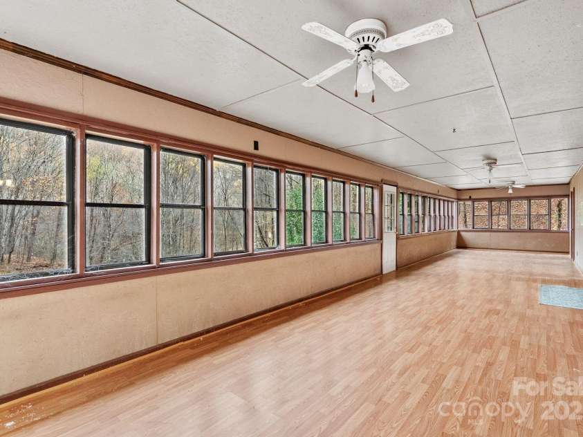 61 Doe Loop, Hot Springs, NC 28743.  MLS# CAR4295989, YatesRealty ID 6481. Sunroom overlooks pond