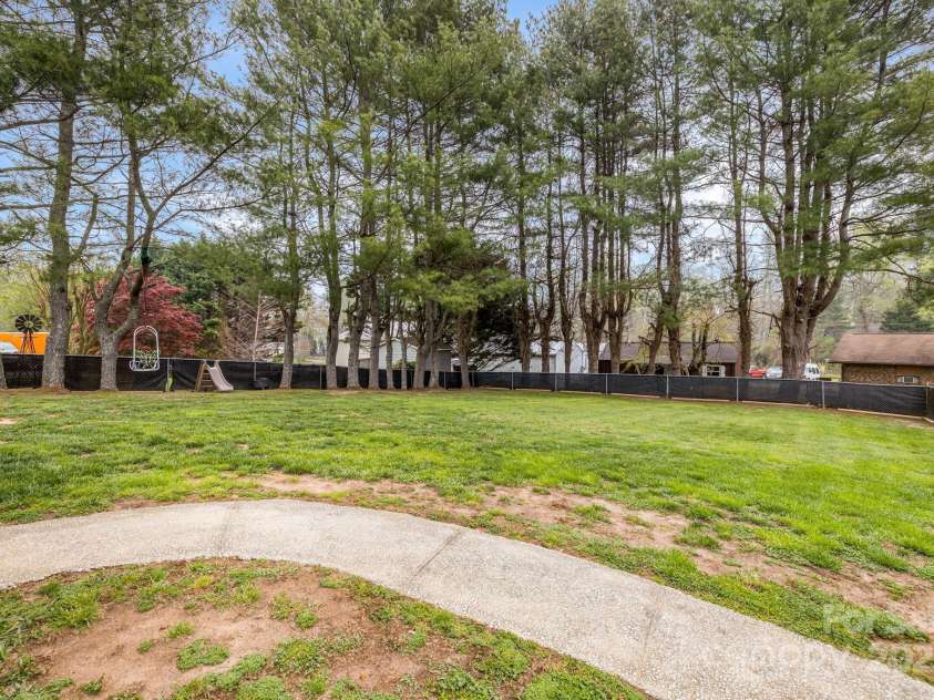 57 Maplewood Knoll Drive, East Flat Rock, NC 28726.  MLS# CAR4239967, YatesRealty ID 6497. Backyard view.