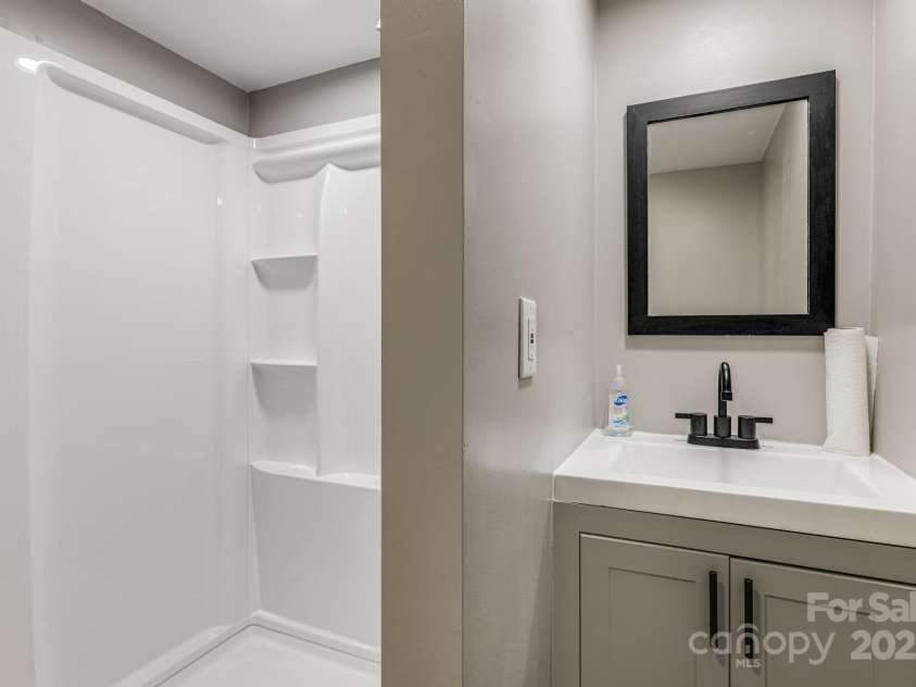 57 Maplewood Knoll Drive, East Flat Rock, NC 28726.  MLS# CAR4239967, YatesRealty ID 6497. Lower level bathroom.